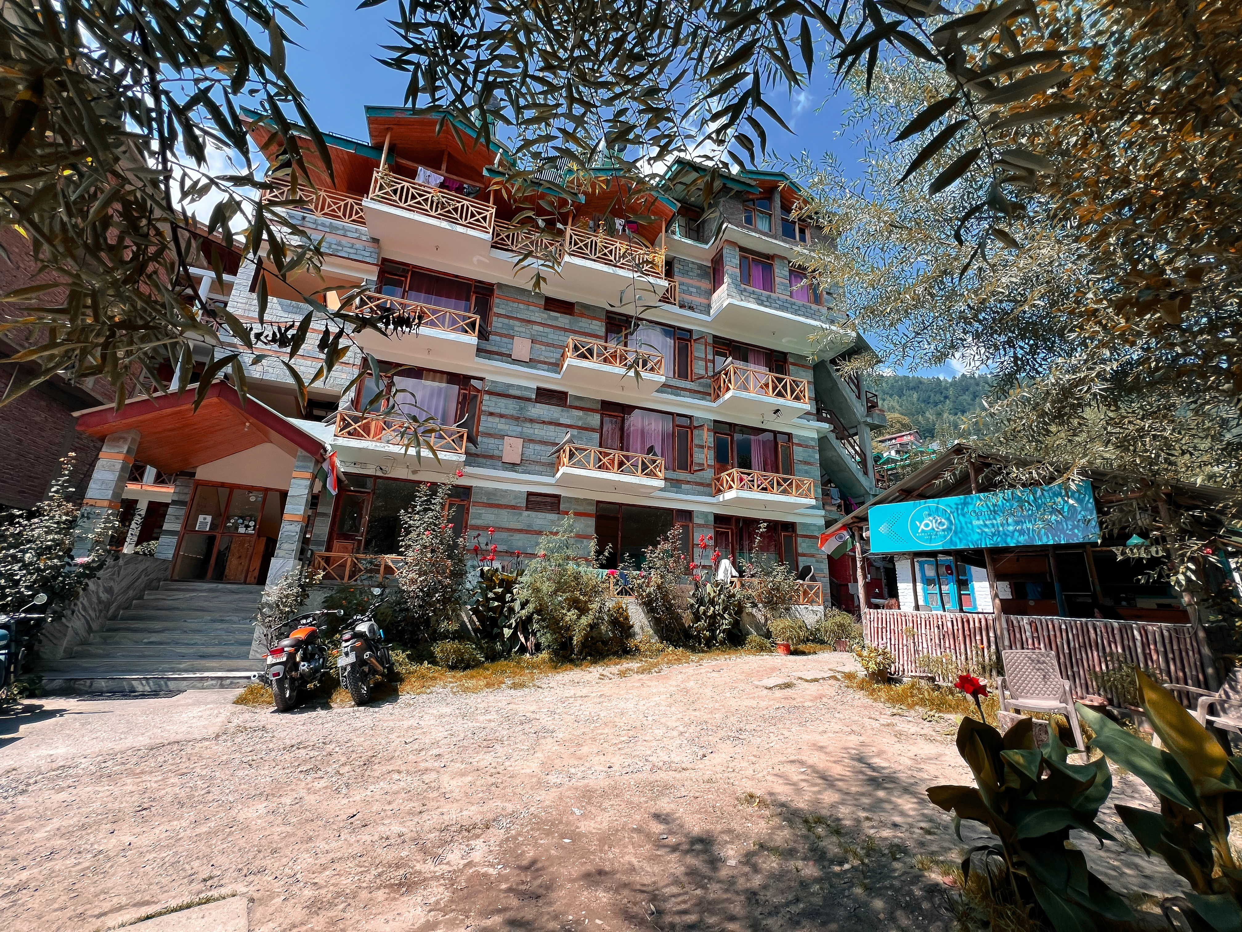 YOLO Social hostel in Old Manali with mountain backdrop